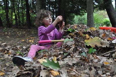 Angelina checking out the pine cone.